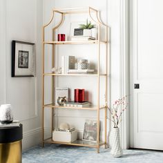 a white and gold book shelf in a living room