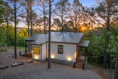 a house in the woods with lights on