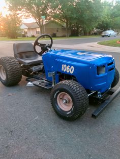 a blue tractor is parked on the street