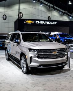 a silver chevrolet suv is on display at an auto show