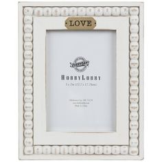 a white and gold frame with the word love on it, sitting in front of a white background