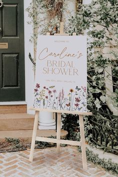 a sign that is standing in front of a door with flowers on it and the words, heaven's bridal shower