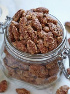 a glass jar filled with nuts on top of a table