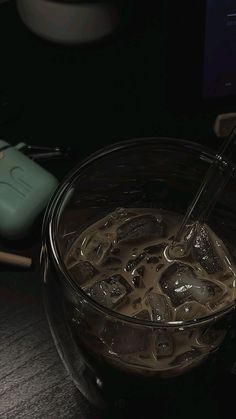 a glass bowl filled with liquid next to a computer mouse