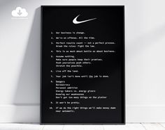 a black framed poster with the words nike written on it in front of a white wall