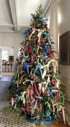 a decorated christmas tree with ribbons on it