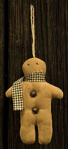 a brown teddy bear hanging from a wooden wall