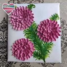 pink flowers are displayed on a white paper with green leaves and hearts in the background