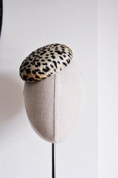 Mini Leopard. The Classics Collection.  A perfectly simple statement headpiece ideal for everyday wear, as well as special occasions. This new size has been hand blocked from thermoplastic and leopard print faux ponyskin short pile fur  using traditional millinery techniques involving steam and wooden hat blocks. Lined, and finished with a wired brim edge to maintain sturdiness, and a hot pink petersham ribbon sweatband. Measures approx 5" - 13.5cm in diameter. Held in place with a fine black me Wedding Dress Buttons, Mini Hats, Hat Blocks, Hat Fascinator, Cocktail Hat, Pillbox Hat, Pill Boxes, Fascinator, Black Metal