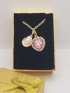 "This is our new Aphrodite necklace that consists of a pink heart with rhinestones and a scallop shell with a tiny pearl inside. The chain will have two options, silver and gold. I can change the shell to silver but cannot change the heart to silver. This is perfect for you to wear to remind you of Aphrodite or to leave as an offering. You could even ask Aphrodite to help enchant the item as a charm.  with love, Lunar Princess my shop no longer accepts cancelations but if an item arrives damaged, I will be happy to replace it. Disclaimer: The information and content provided on this [website/show/product/etc.] is intended for entertainment purposes only. It should not be construed as professional advice, or relied upon for making important decisions. The content is provided without warrant Aphrodite Style, Aphrodite Jewelry, Aphrodite Necklace, Fantasy Objects, Ancient Greek Jewelry, Coquille Saint Jacques, Professional Advice, Scallop Shell, Greek Jewelry