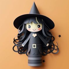 a paper doll is dressed in a witches hat and black dress, standing on a yellow background