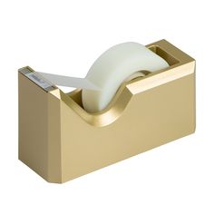 a gold tissue dispenser with a roll of toilet paper in it