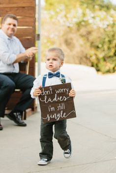 a little boy holding a sign that says don't worry leaders i'm still single