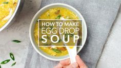 a person holding a spoon over a bowl of egg drop soup with the words how to make egg drop soup