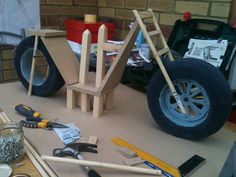 various tools are sitting on a table next to a tire and some other construction materials