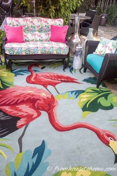 an outdoor area with chairs, couches and rugs that have flamingos on them