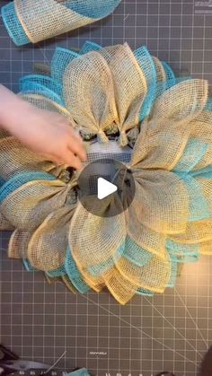 someone is working with fabric to make a flower