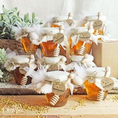 several honey jars filled with honey sitting on top of a wooden table