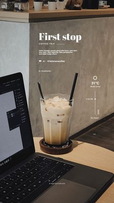 an open laptop computer sitting on top of a wooden table next to a cup of coffee