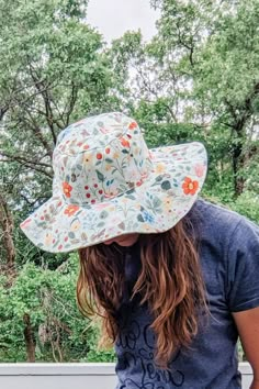 a woman with long hair wearing a hat