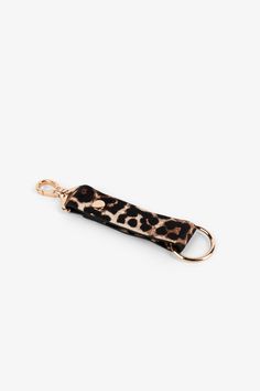 a leopard print keychain on a white background