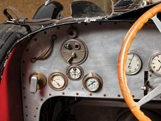 the dashboard of an old race car with gauges