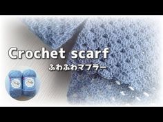 the crochet scarf is blue and has two pairs of slippers on it