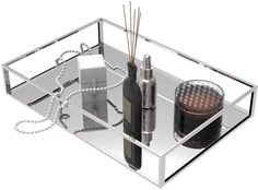 a glass tray with bottles and candles on it