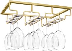 four wine glasses hanging from a gold rack