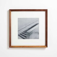 a black and white photo of stairs in a frame on the wall next to a door