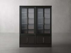 an empty glass door cabinet with shelves in the middle and two doors on each side