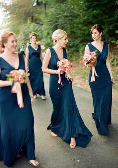 the bridesmaids are walking down the road together