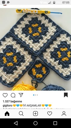 two crocheted coasters are sitting next to each other on a table with yarn