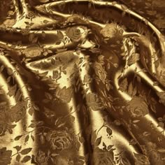 an image of gold fabric with flowers on it