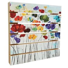 an art piece with colorful flowers painted on the side and wood strips in different colors