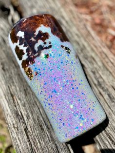 a glass bottle sitting on top of a wooden bench