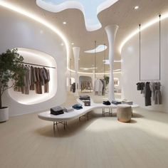 the inside of a clothing store with white walls and wooden flooring is lit by recessed lighting