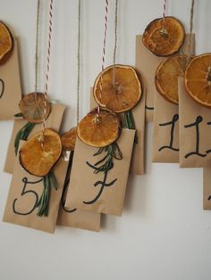 several pieces of fruit hanging from twine with tags attached to the strings that have numbers on them