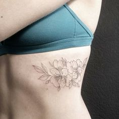 a woman with a flower tattoo on her stomach