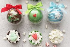 four decorated christmas ornaments sitting next to each other