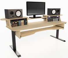 a computer desk with speakers and a monitor