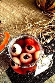 a jar filled with fruit sitting on top of a table