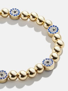 Embellish your energy with this evil eye accessory. The Isabella Bracelet shines with gold beads and royal blue evil eye pavé stones. Plus, it stretches and adjusts to fit anywhere on your wrist — or any of your friend’s. This bracelet features 6mm gold ball beads. Bubble Bracelet, Gold Medallion Necklace, Apple Earrings, Crystal Anklet, Slider Bracelet, Gold Medallion, Personalized Pendant, Medallion Necklace, Blue Evil Eye