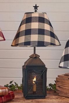 a lamp that is sitting on top of a table next to books and other items