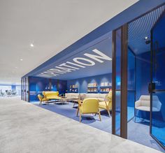 an office with blue walls and yellow chairs