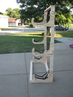 a wooden sculpture sitting on top of a sidewalk