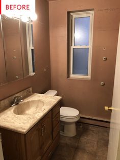 a bathroom with a toilet, sink and mirror in it's corner before remodeling