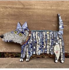 a wooden bench with a dog made out of strips of paper