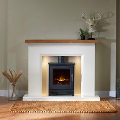 a living room with a fire place next to a rug and vases on the floor