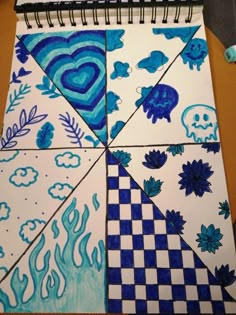 a spiral notebook with blue and white designs on it